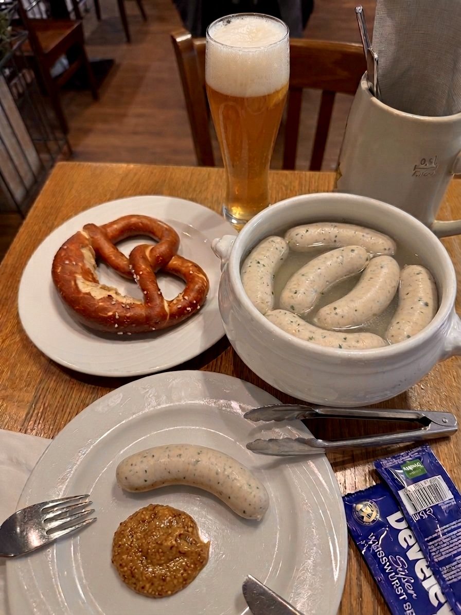 Bavarian breakfast: white sausage, a pretzel, sweet mustard and a wheat beer.